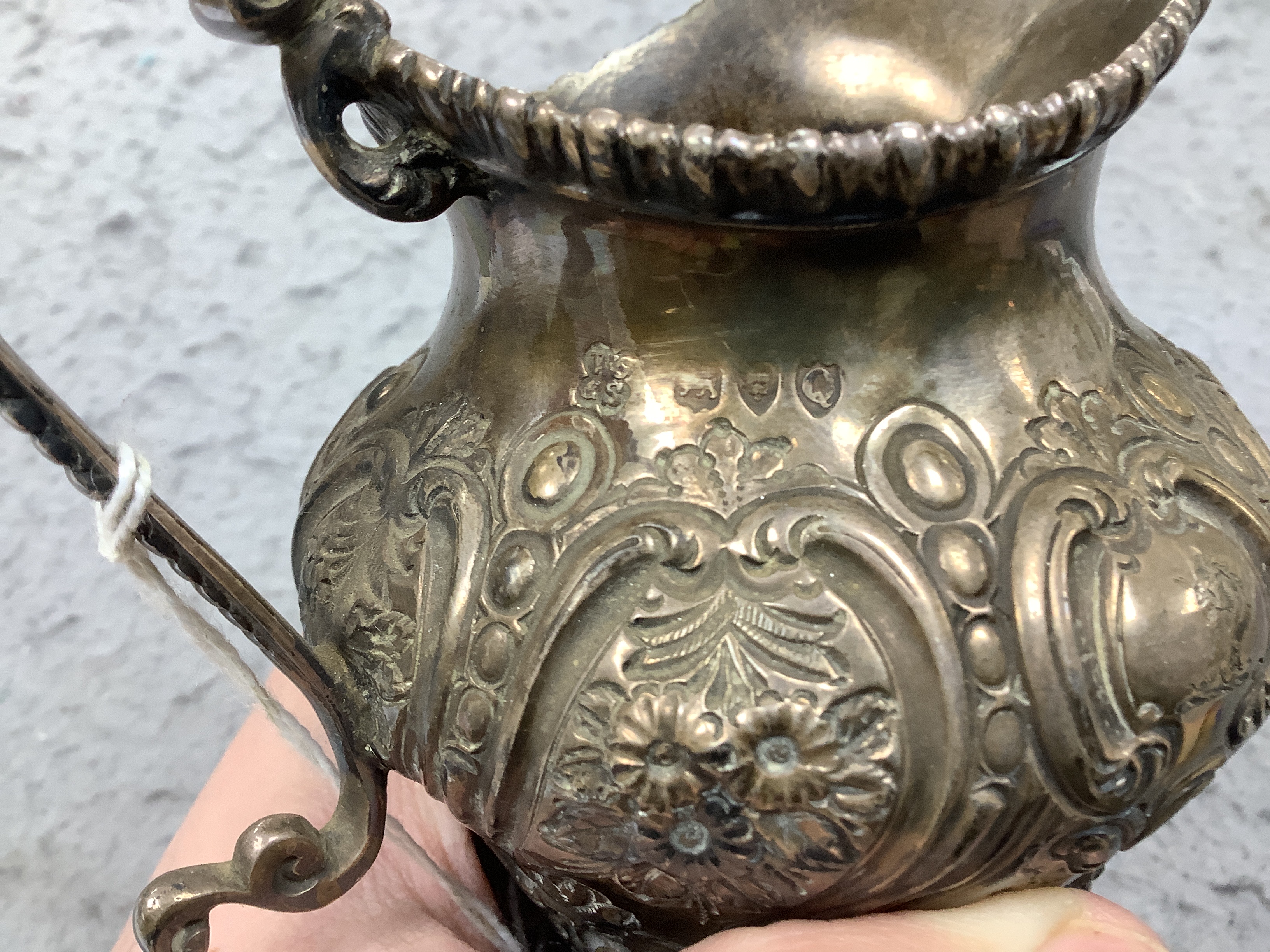 A late Victorian embossed silver inverted pear shaped three piece tea set, W & C Sissons, London, 1891, gross weight 41oz.